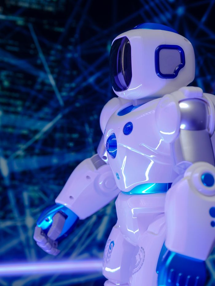 about-us Close-up of a modern humanoid robot with glowing blue lights and futuristic design.